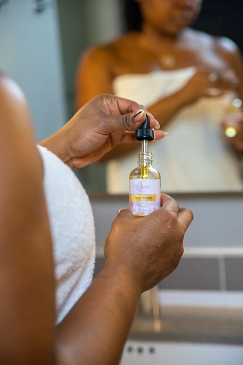 Woman applying azelaic acid serum with a dropper as part of her skincare routine