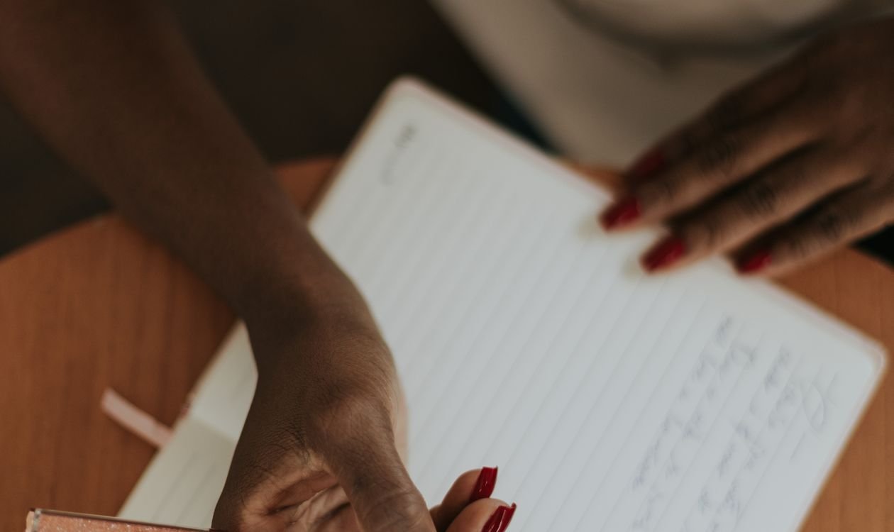 Close-up of a hand writing in a notebook