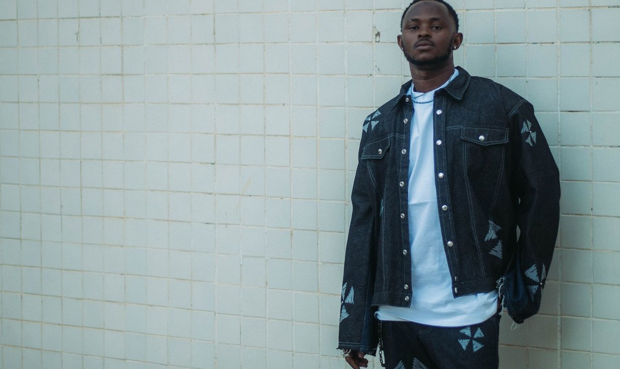 Man wearing a dark denim jacket with jeans in a double denim outfit