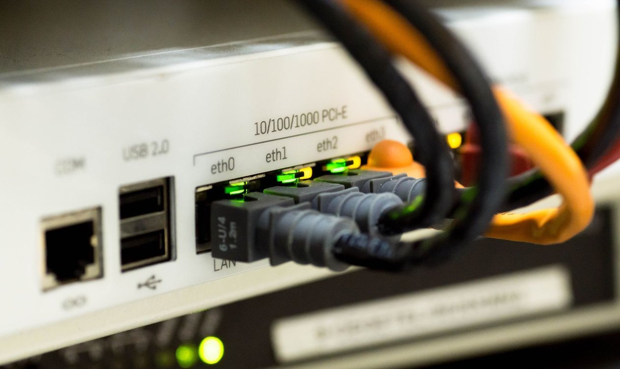 Ethernet cable plugged into the back of a router for a wired connection