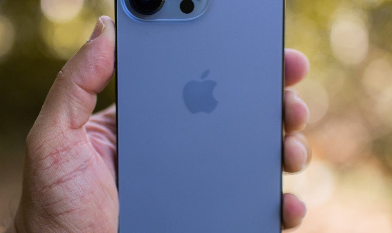 Person holding an iPhone to check its iCloud backup status