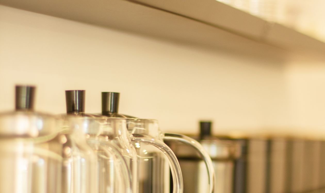 Clear jars of dry goods arranged neatly on kitchen shelves