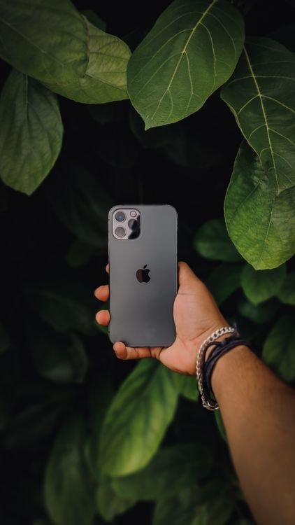 Hand holding an iPhone, showing how to lock apps with Face ID for privacy