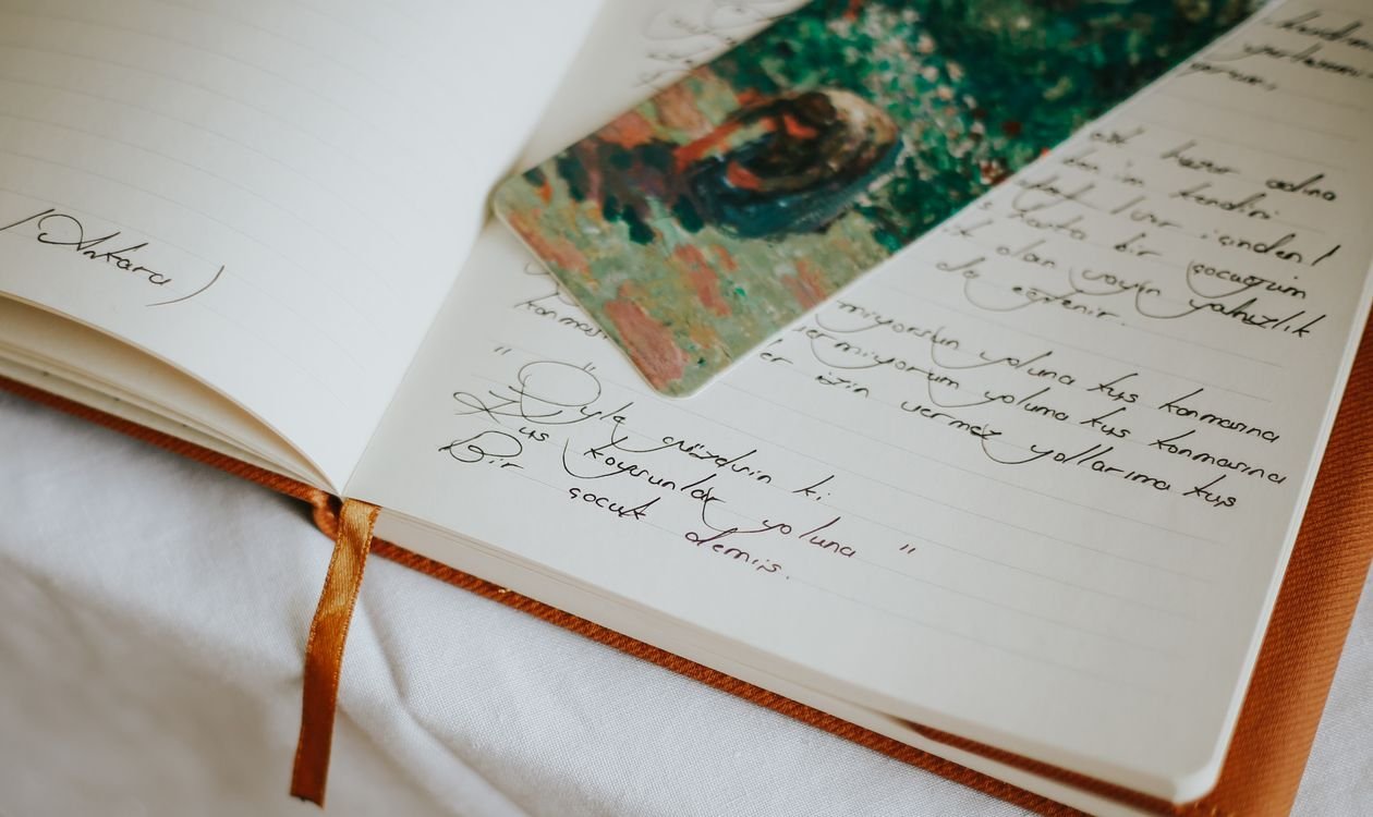 Open journal with handwritten notes and a bookmark