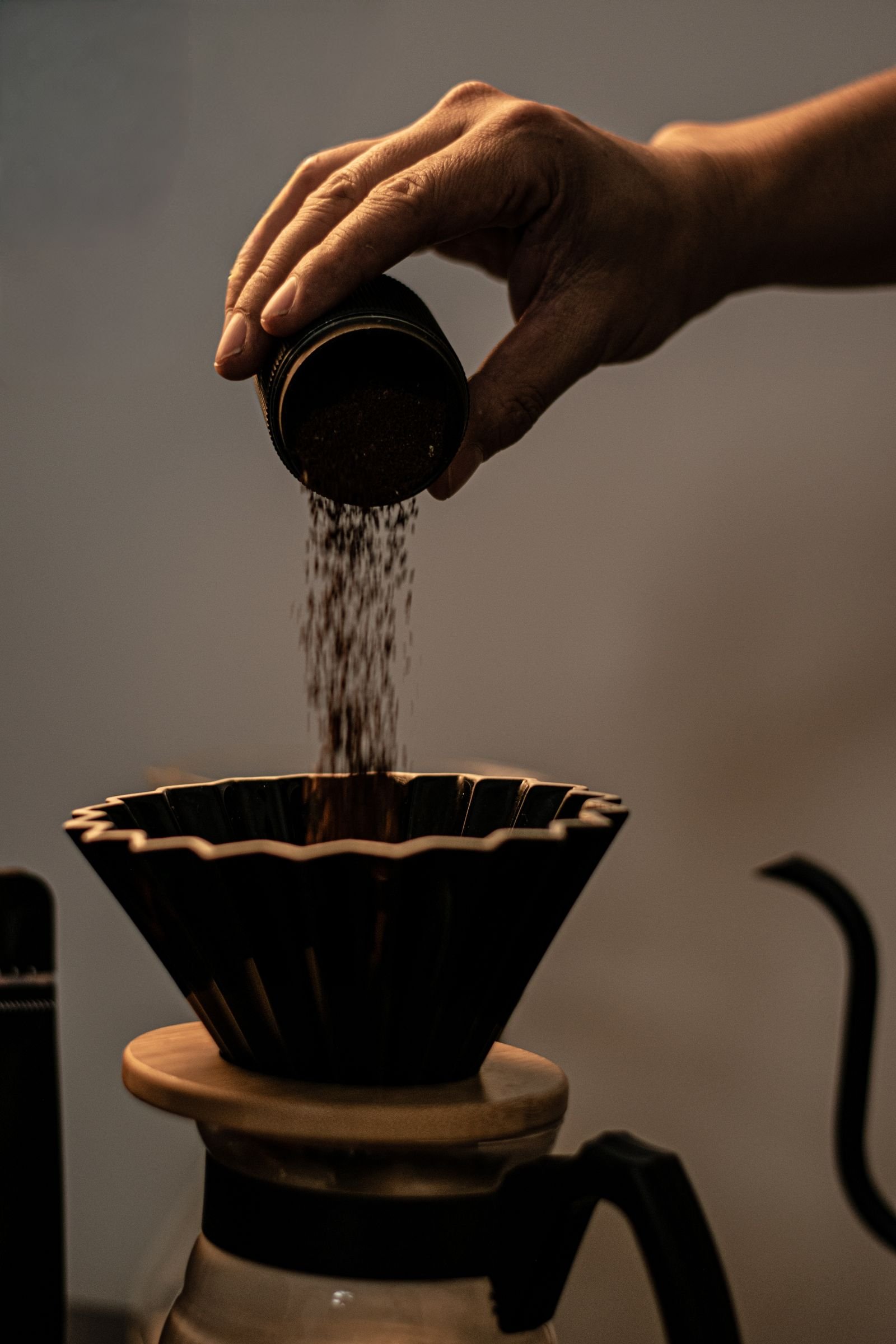 Pouring coffee grounds into a filter for cold brew