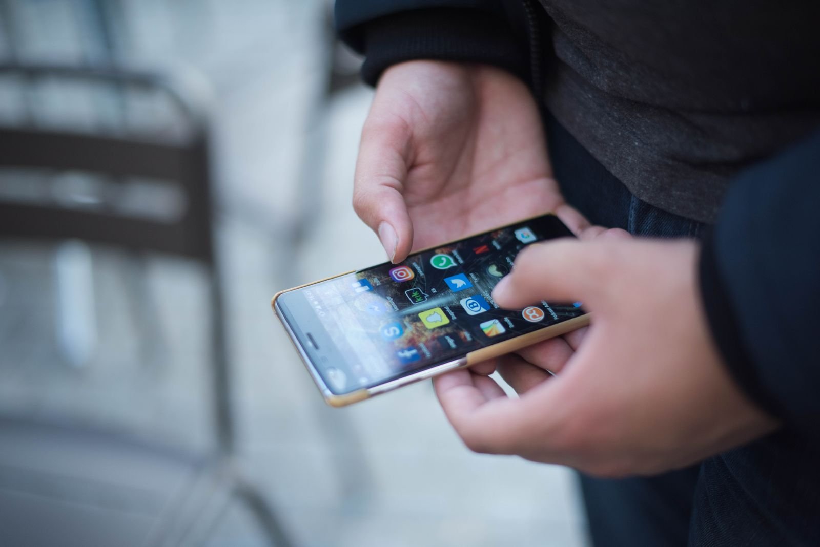 Person scrolling through apps on an iPhone with a full cache